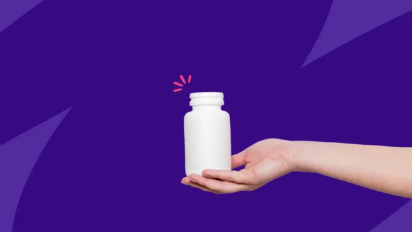 A hand holding an OTC pill bottle: Can you take Allegra and Zyrtec?