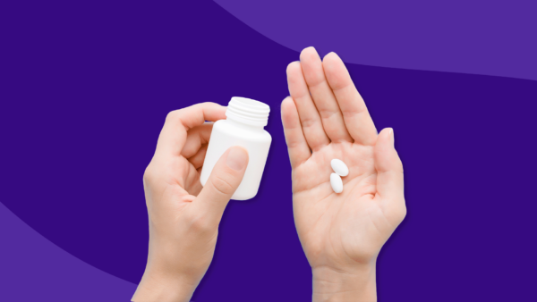 Hand holding two Rx pills and Rx pill bottle: Nexletol alternatives