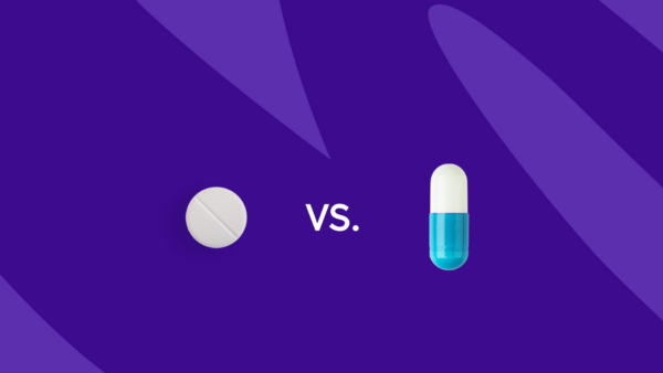 A round pill and a capsule with "vs." between them: Vraylar vs. Latuda: Differences, similarities & side effects
