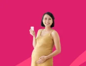 A woman holding a bottle of pills | Nurtec and pregnancy