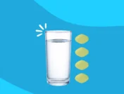 glass of water next to tablets - how much water should you drink when taking Farxiga