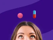 Women looking up at an iburpofen and Tylenol pill: Which pain medication is best for back pain?