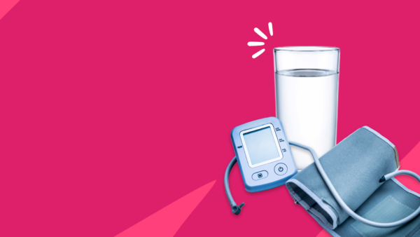 blood pressure cuff next to a glass of water - does drinking water lower blood pressure