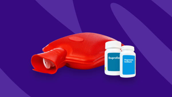 Hot water bottle for pain relief with OTC pill bottles: Ibuprofen and sore muscles