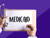 A person's hand's holding a clipboard and a stethoscope, writing MEDICAID on the clipboard: Does Medicaid cover Quviviq?