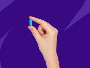 A hand holding a blue capsule: Do you have to take valacyclovir forever?