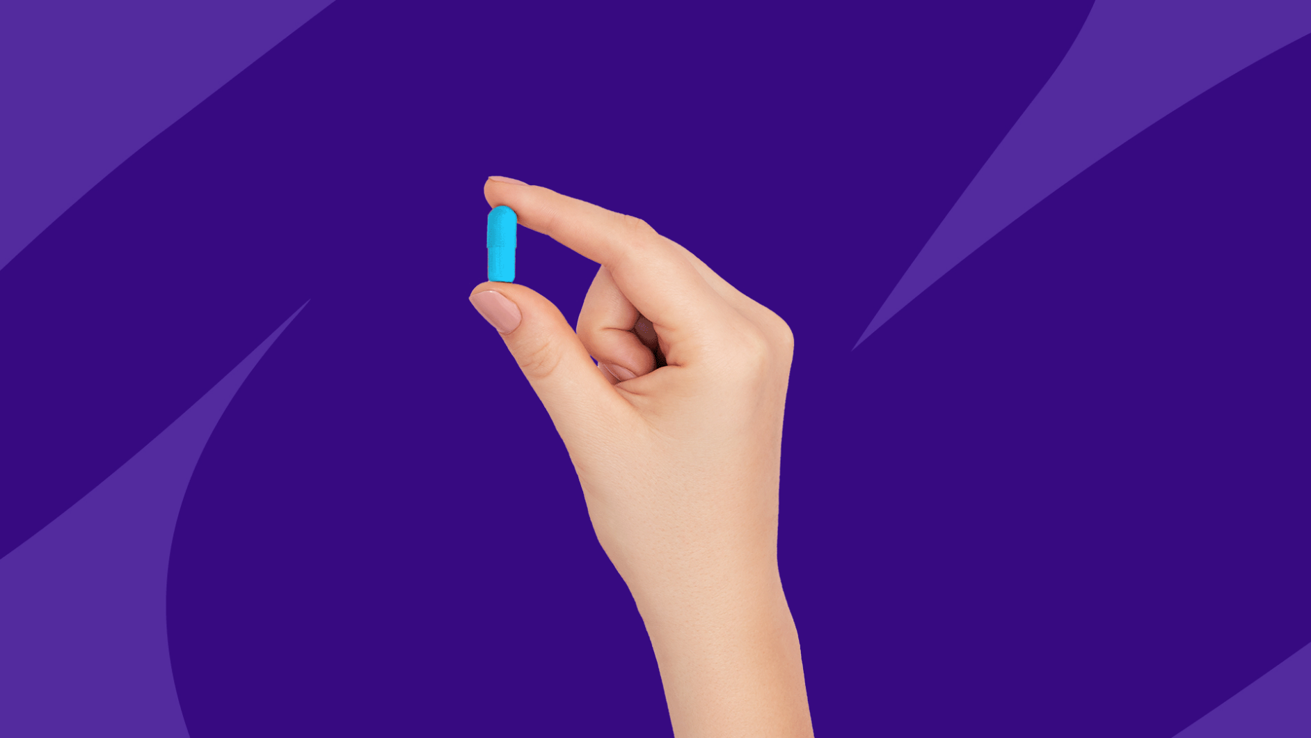 A hand holding a blue capsule: Do you have to take valacyclovir forever?