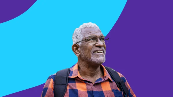 An older man smiling: Explore mental health resources for seniors